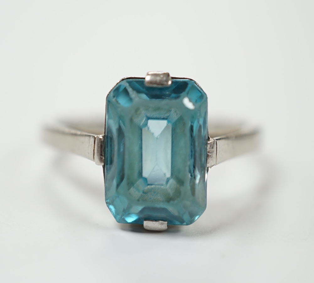A mid 20th century white metal (stamped platinum) and single stone emerald cut blue zircon set ring, size K, gross weight 3.9 grams. Condition - poor to fair